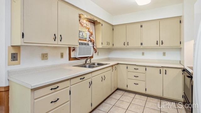 kitchen featuring cream cabinetry, black range with electric stovetop, light tile patterned floors, and sink