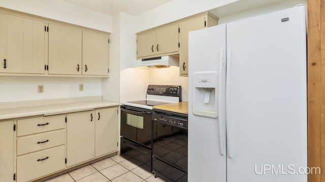 kitchen with cream cabinetry, light tile patterned floors, and black appliances