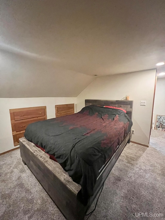 carpeted bedroom featuring lofted ceiling