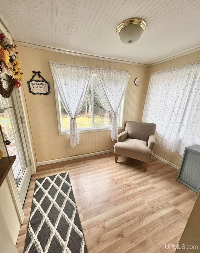 sitting room featuring crown molding and light wood-type flooring