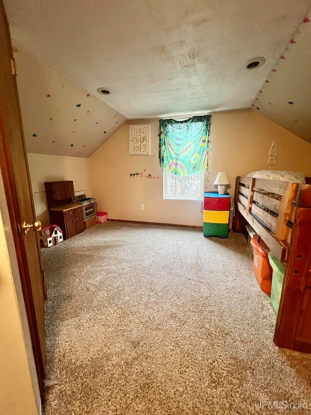 bonus room featuring carpet flooring, a textured ceiling, and lofted ceiling