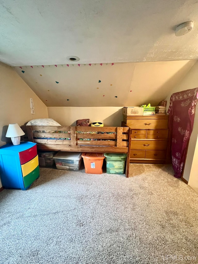 bedroom with carpet and lofted ceiling