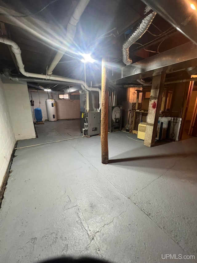 basement featuring heating unit and water heater