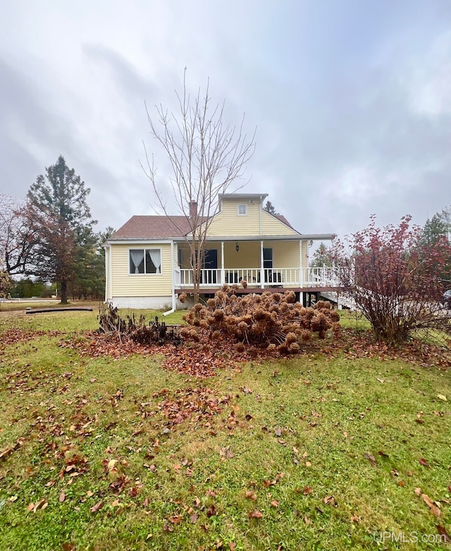 rear view of property with a lawn