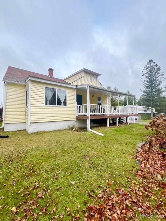 rear view of property with a lawn