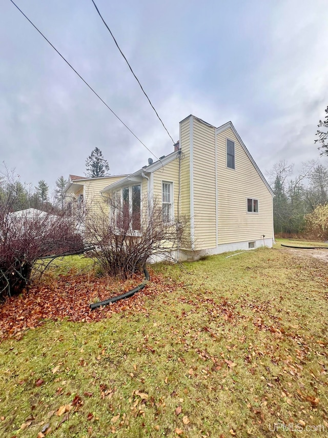 view of property exterior featuring a yard