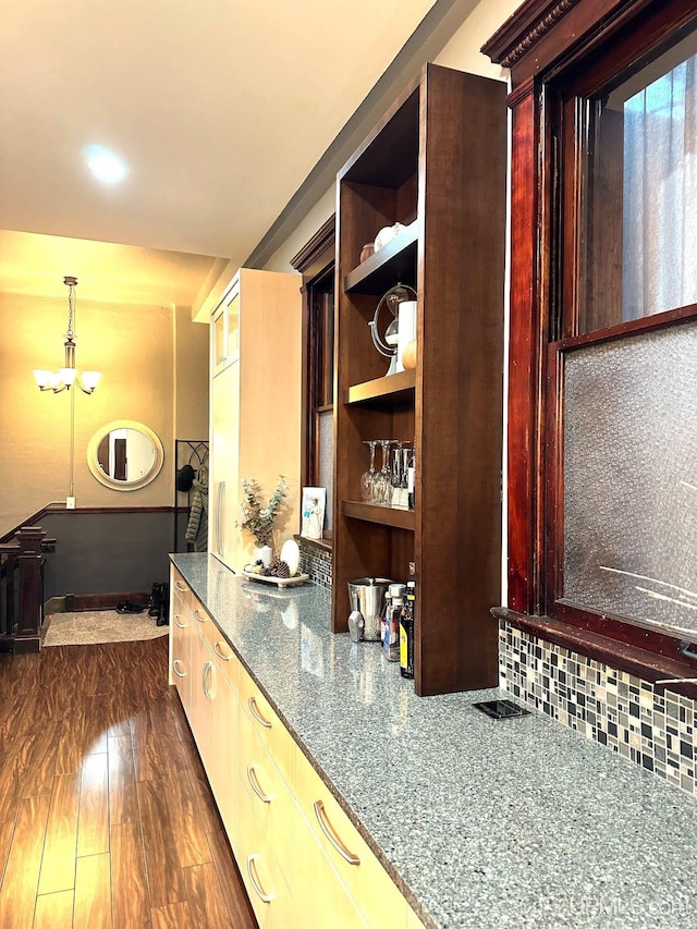 318 Iron St, Negaunee, MI 49866 - kitchen featuring backsplash, dark stone countertops, open shelves, and dark wood-style floors