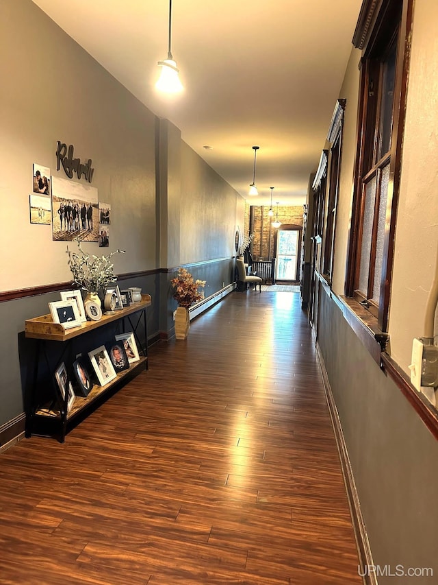 318 Iron St, Negaunee, MI 49866 - corridor with a baseboard heating unit, dark wood-style flooring, and baseboards