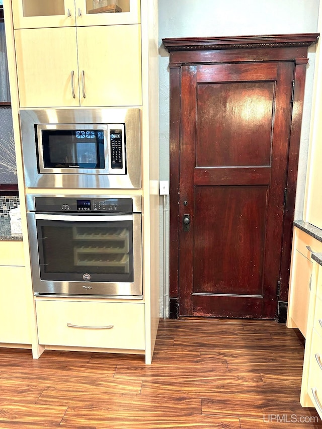 kitchen with hardwood / wood-style floors and appliances with stainless steel finishes