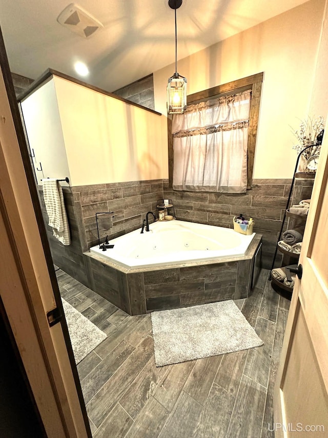 318 Iron St, Negaunee, MI 49866 - full bathroom featuring a whirlpool tub, wood tiled floors, and wainscoting