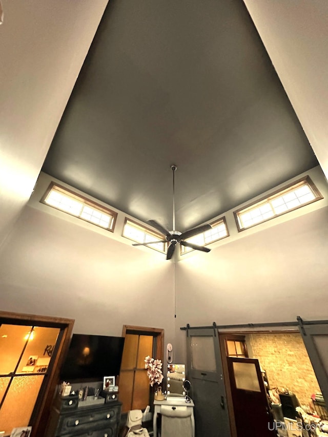 room details with ceiling fan and a barn door