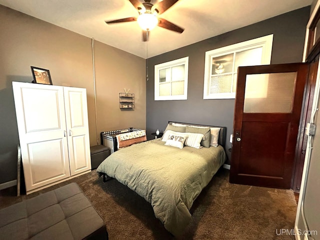 carpeted bedroom featuring ceiling fan and a closet