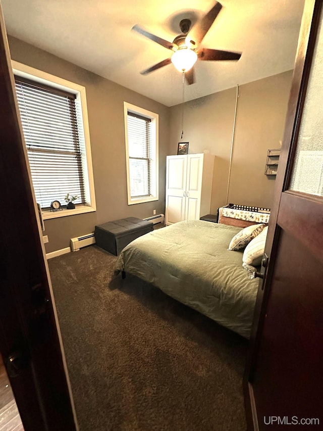 318 Iron St, Negaunee, MI 49866 - bedroom with a baseboard heating unit, baseboards, ceiling fan, and carpet flooring