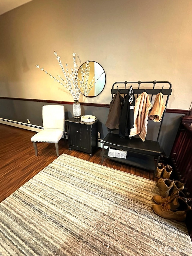 sitting room with dark wood-type flooring and a baseboard heating unit