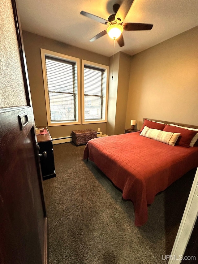 carpeted bedroom featuring a baseboard radiator and ceiling fan