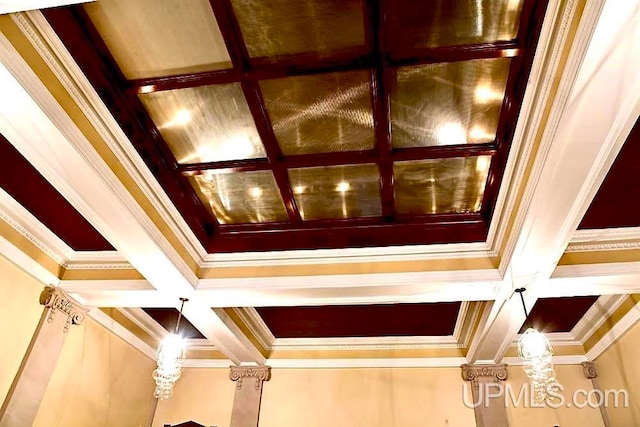 interior details featuring crown molding, beamed ceiling, and coffered ceiling