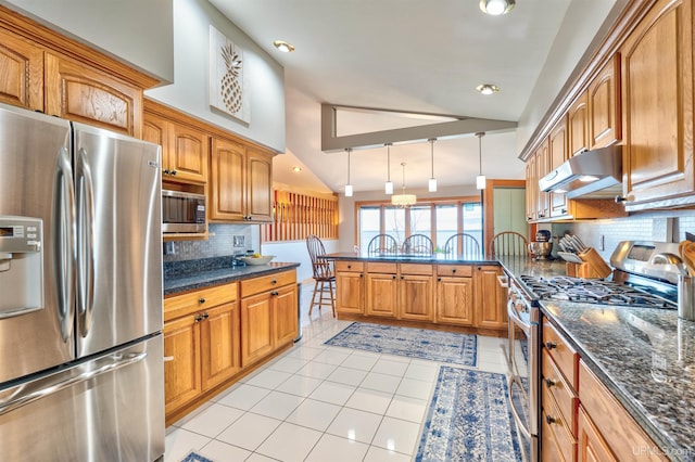 kitchen featuring pendant lighting, dark stone counters, light tile patterned floors, tasteful backsplash, and stainless steel appliances