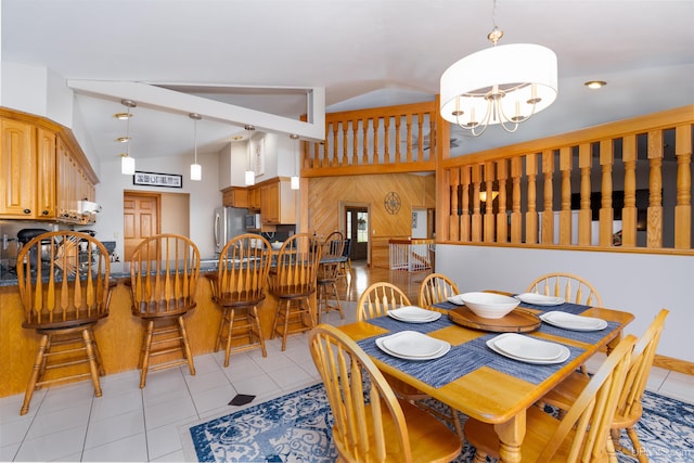 dining room featuring light tile patterned flooring, lofted ceiling, and a notable chandelier