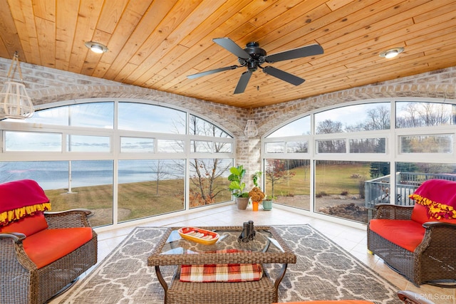 sunroom / solarium featuring wood ceiling, a water view, lofted ceiling, and a wealth of natural light