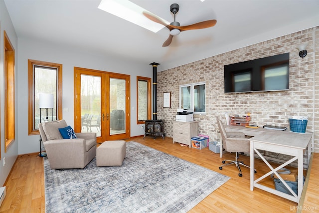 living room with french doors, brick wall, ceiling fan, wood-type flooring, and a baseboard radiator