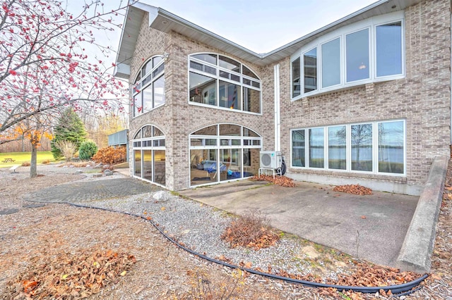 back of property featuring a patio area and ac unit