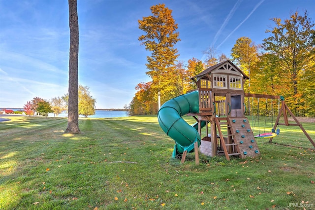 view of play area with a lawn and a water view