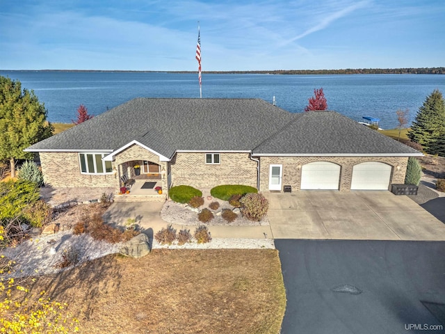 view of front of property with a water view and a garage