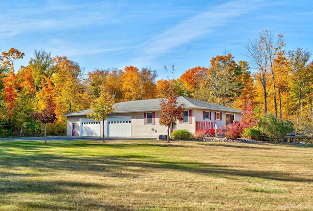 ranch-style home featuring a front lawn and a garage