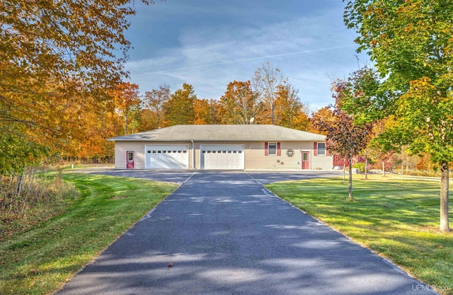 view of front of home with a garage and a front yard