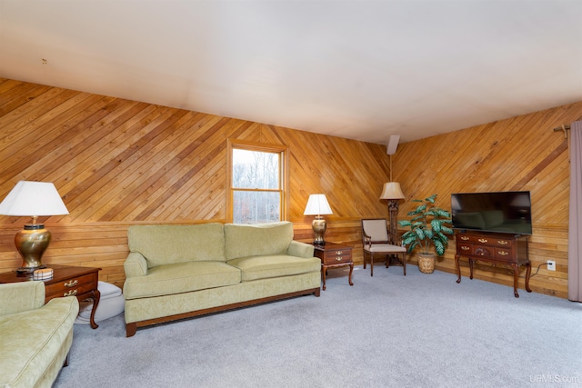 carpeted living room featuring wooden walls