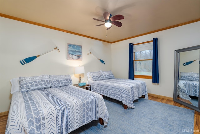 bedroom featuring ceiling fan, hardwood / wood-style floors, and crown molding