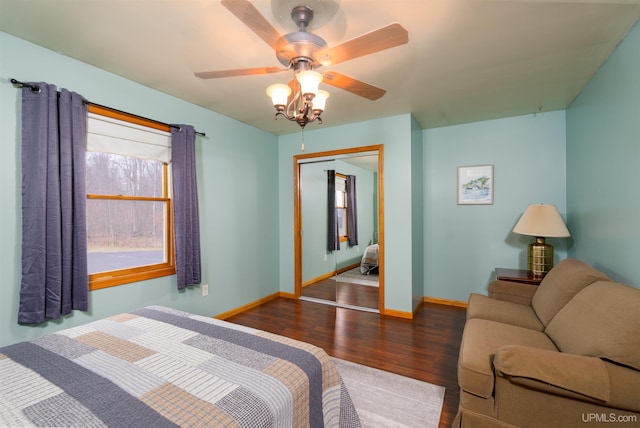 bedroom with ceiling fan, dark hardwood / wood-style floors, and a closet