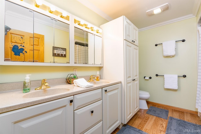 bathroom with hardwood / wood-style floors, vanity, toilet, and crown molding