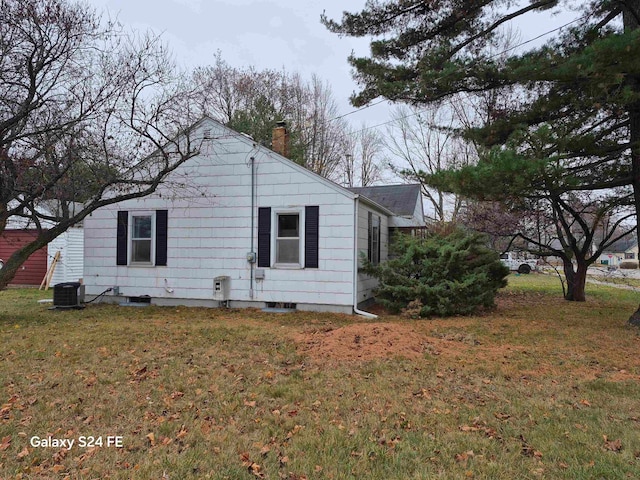 view of side of property with a yard