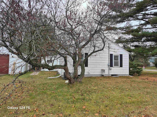 view of side of home with a lawn