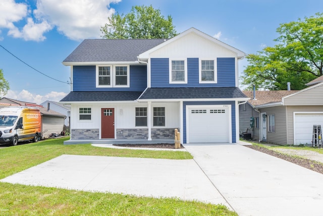 view of front of property featuring a front yard and a garage