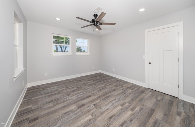 unfurnished room featuring ceiling fan and dark hardwood / wood-style flooring