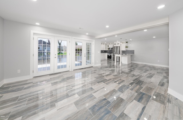 unfurnished living room with french doors