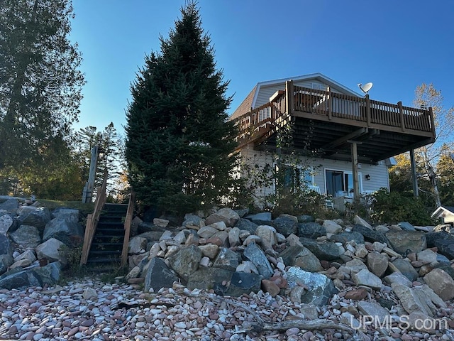 view of property exterior featuring a wooden deck