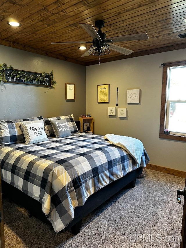 carpeted bedroom with ceiling fan and wood ceiling