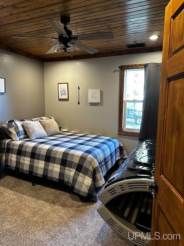 bedroom featuring ceiling fan, carpet floors, and wooden ceiling