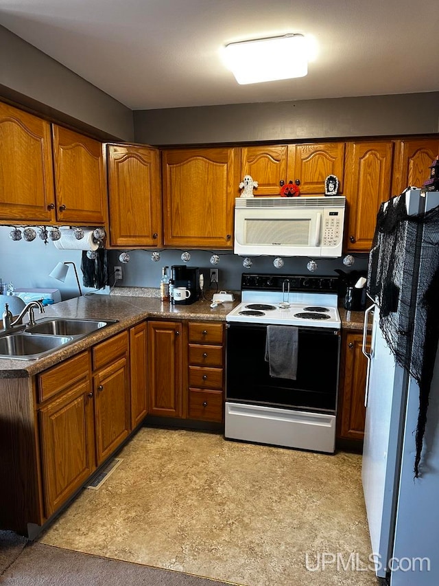 kitchen featuring white appliances and sink