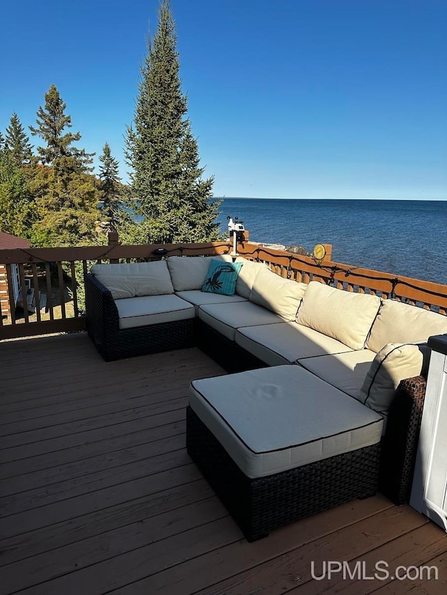 wooden deck featuring a water view and an outdoor hangout area