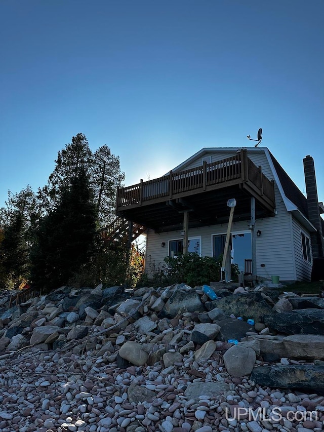 rear view of property featuring a deck