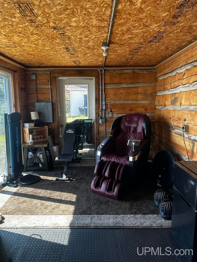 interior space with electric panel and wood walls