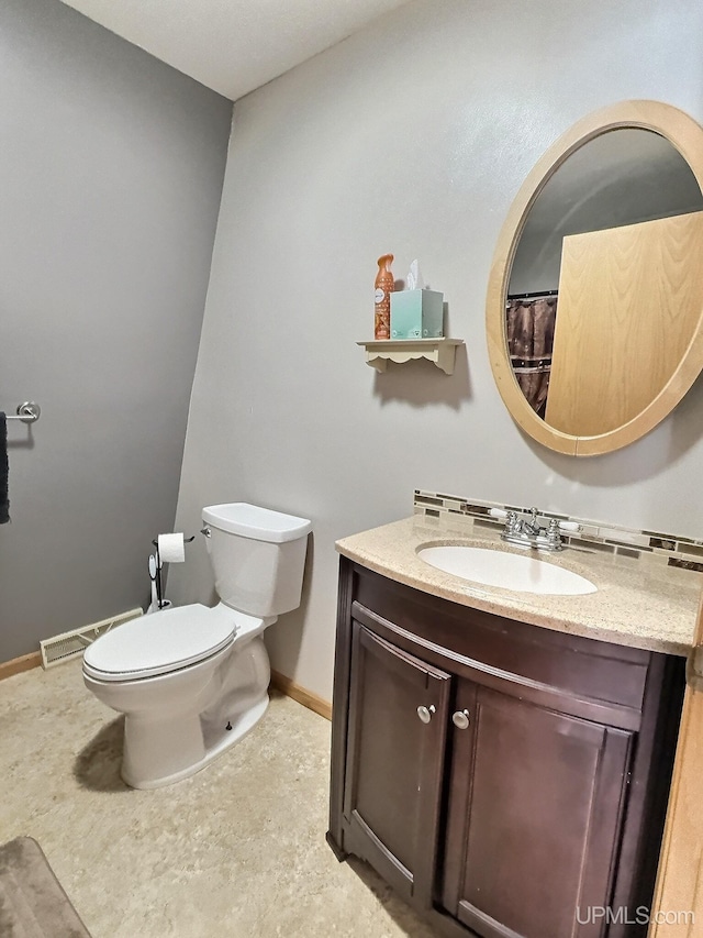 bathroom featuring vanity and toilet