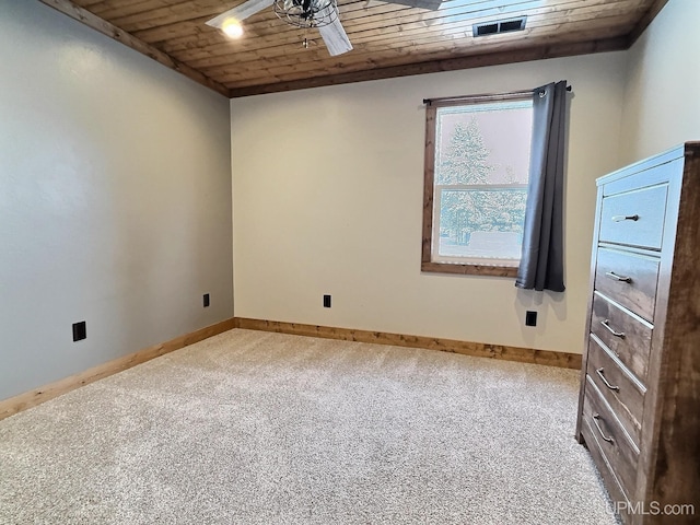 empty room featuring wood ceiling, ceiling fan, and carpet flooring