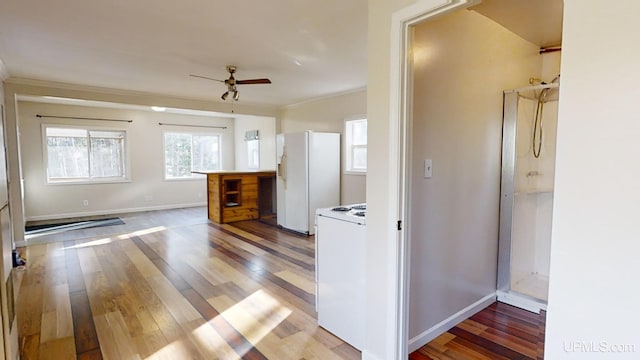 kitchen with ceiling fan, ornamental molding, white appliances, and hardwood / wood-style flooring