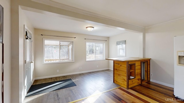 unfurnished room featuring crown molding and dark hardwood / wood-style floors