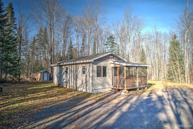 view of front of house with a storage shed